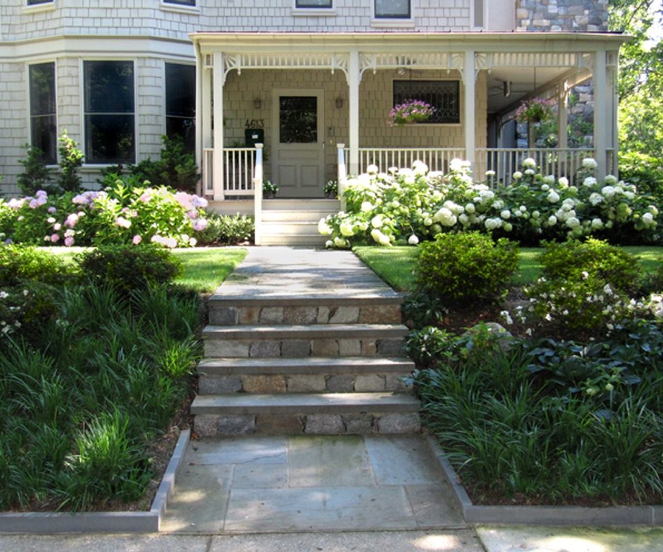 Shrubs and perennials planted along a sunny foundation bed.